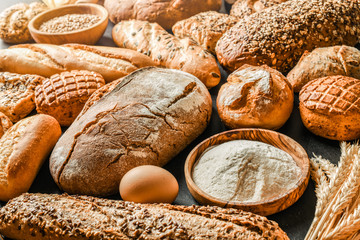 Fresh fragrant breads on the table. Bakery food concept panorama or wide banner photo.