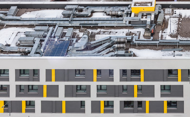 Air condition system on the white yellow pattern apartment building roof top