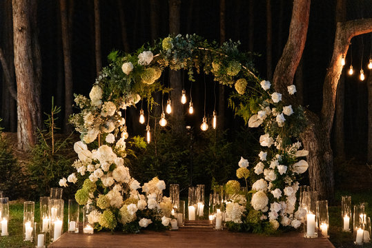 Evening wedding ceremony with garlands of lamps