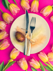 Easter table cutlery with tulips, eggs, feathers