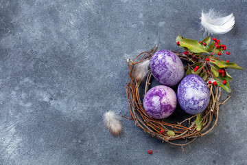 Easter background with painted eggs in nest.