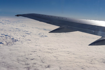 Fototapeta na wymiar Photo of a plane wing on sunny day