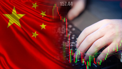 The Chinese stock exchange. Work on the Chinese stock exchange. Changes in stock prices on the exchange of the China. Broker's hands and changes in quotes on the background of the flag of PRC.