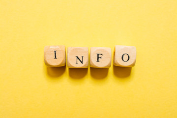 the word Info, text made with dice on yellow background