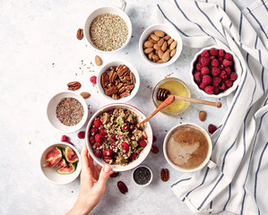 Healthy breakfast, oatmeal with raspberries, figs and nuts and seeds. The concept of a healthy lifestyle, diet. Top view