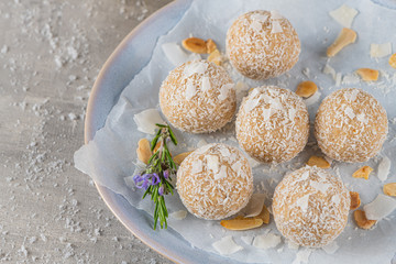 Homemade sweet white chocolate and coconut in a plate. Candy - snowball truffles on a Christmas table.