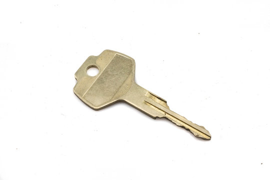 A Gold Car Key, Close Up, Isolated On A Clean, White Background.  Shot In Macro.