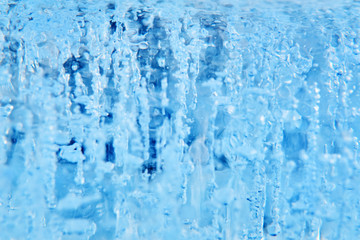 blurred background - ice or water stream with bubbles