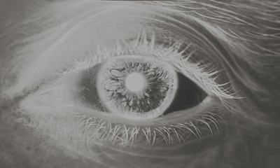 Black and white macro image with the brown eye and retina of a man.