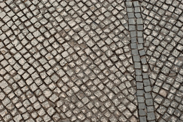 Paving the street in the city. Replacement of old paving tiles. Repairs. The pits on the roads, the old damaged cobblestone.