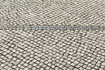 Paving the street in the city. Replacement of old paving tiles. Repairs. The pits on the roads, the old damaged cobblestone.