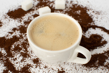 Espresso coffee on a white background with ground coffee. Still-life. Selective focus.