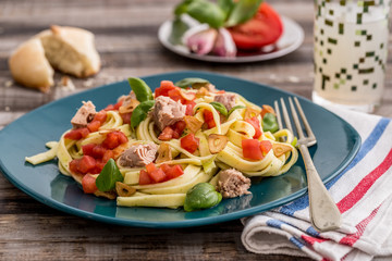 Sauteed egg noodles with tuna tomato and basil