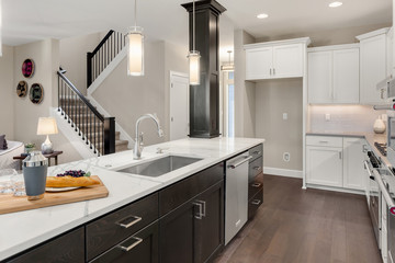 Kitchen in new home with large island and stainless steel appliances