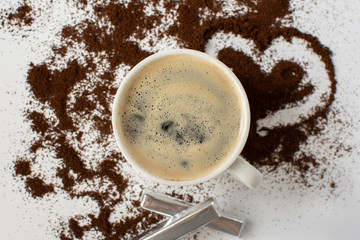 Espresso coffee on a white background with ground coffee. Still-life. Selective focus.