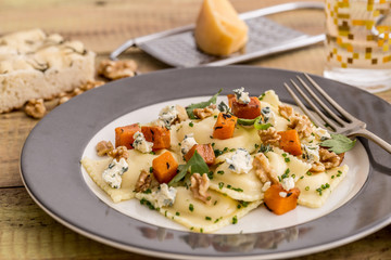 Ricotta sorrentinos with blue cheese and walnut sauteed pumpkin