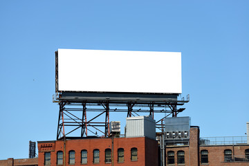 Large Billboard On Roof Top Of Brick Building - obrazy, fototapety, plakaty