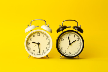 Time background concept. Vintage classic alarm clock on yellow empty background. Time management concept