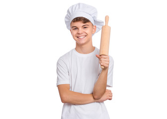 Portrait of handsome teen boy in chef hat holding rolling pin, isolated on white background....