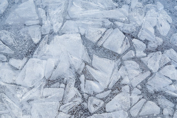 Obraz premium Macro close-up of ice on a frozen lake in the winter. Minimal full frame abstract background. Copy space.