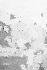 Close-up of a weathered and old concrete wall, white paint has peeled off. High resolution abstract full frame textured background in black and white.