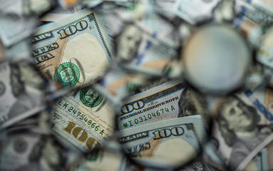 Background from parts of dollar bills in round sectors of different sizes. Selective focus.