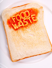 The words food waste spelled out with alphabet spaghetti on a piece of toast