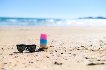 Ice cream with sunglasses on the beach with copying area