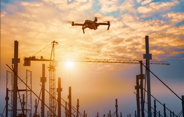 Drone over construction site. video surveillance or industrial inspection