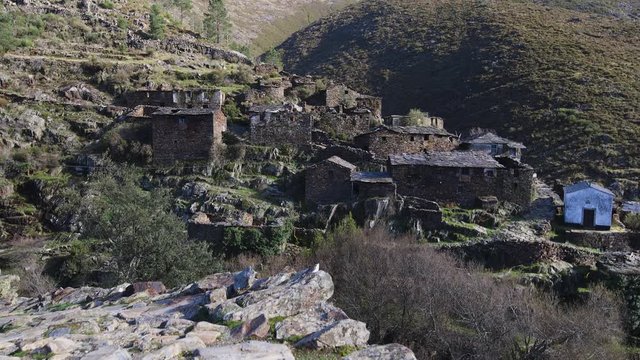 Tilt up revealing an magical village in the mountains. Drave, Arouca, Portugal.