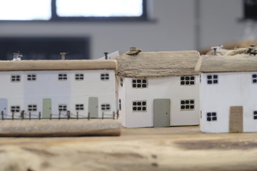 Exeter, Devon/UK- August 3 2019: Small wooden decorations depict miniature houses with selective focus