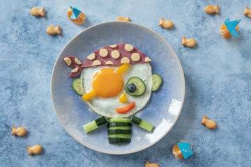 Funny pirate fried egg with ham and vegetable for kid breakfast
