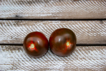 black spanish tomatoes on a white background