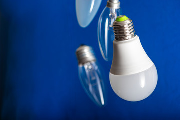 Different bulbs fall down. Electric lighting. Blurred background. Power saving LED lamps in...