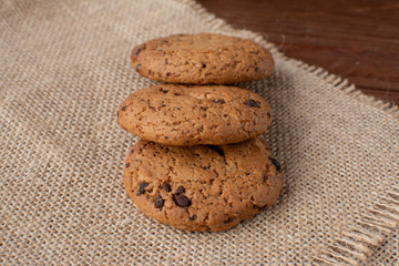 Homemade cow's milk with cookies on a wooden background. Rustic style. Still-life.