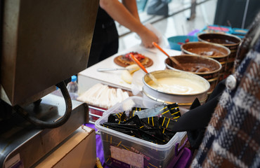 White and black melted chocolate in tin cans