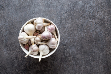 white bowl full of fresh organic garlic