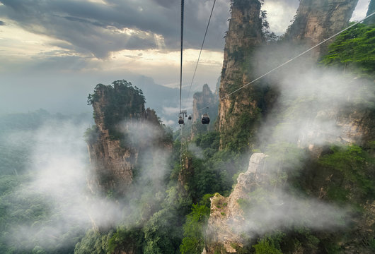 Aerial panorama. Cable car crossing giant pillar mountains in Tianzi Mountain and Yellow Stone Stronghold (Huangshi Zhai), Zhangjiajie National Park, China