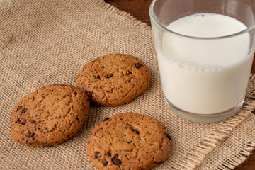 Homemade cow's milk with cookies on a wooden background. Rustic style. Still-life.