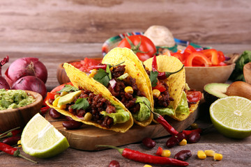 Mexican tacos with beef, tomatoes, avocado, chilli and onions. Handmade tortilla with pork