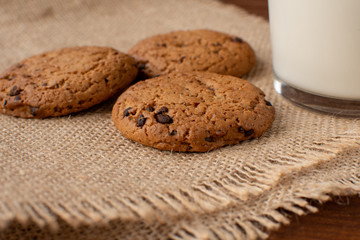 Homemade cow's milk with cookies on a wooden background. Rustic style. Still-life.