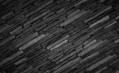 Texture of black brick slate wall, dark grey stone background