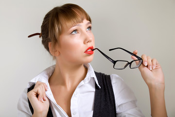 Portrait of elegant young beautiful caucasian woman in formal clothes posing over gray background. The concept of beauty and success. Attractive woman concept. Copyspace