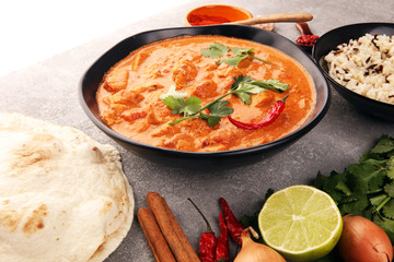 Chicken tikka masala spicy curry meat food in pot with rice and naan bread. indian food