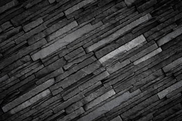 Texture of black brick slate wall, dark grey stone background