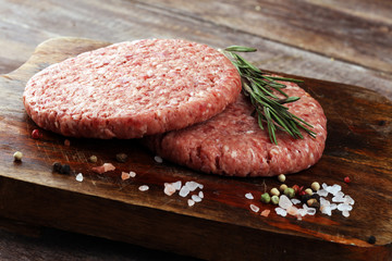 raw patty for angus burger on wooden cutting board. patty for burger