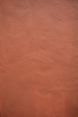 A stone texture wall in pink-brown paint.