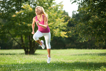 Beautiful young woman exercising in the nature