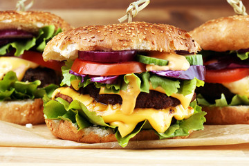 Tasty fresh meat burgers with salad and cheese. Homemade angus burger.