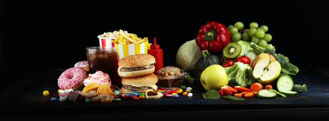 healthy or unhealthy food. Concept photo of healthy and unhealthy food. Fruits and vegetables vs...
